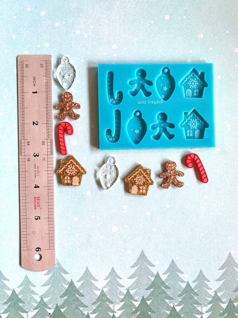 Molde de silicón 4 diseños, casita de jengibre, galleta hombre de jengibre, bastón de navidad y bombillo de navidad